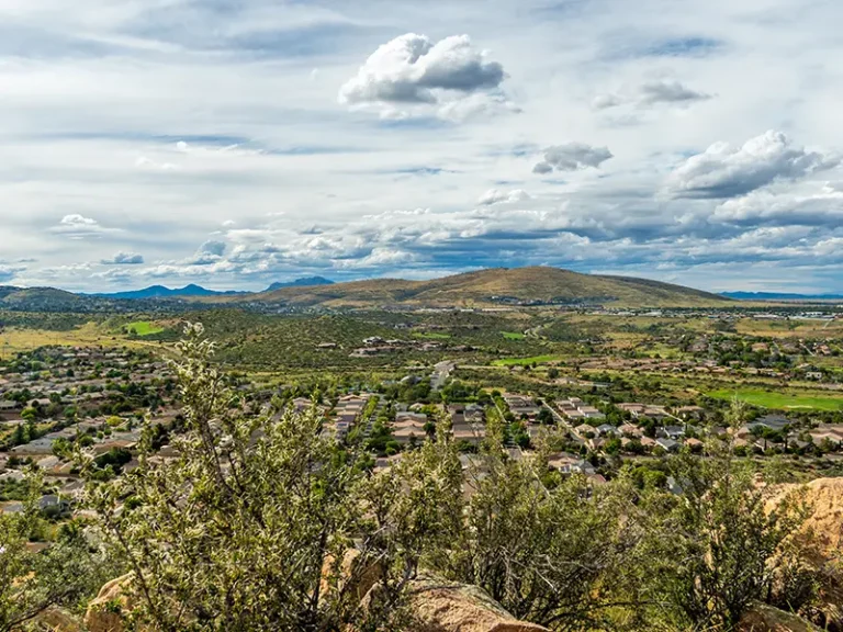 Scenic view of Arizona, with residential neighborhoods, rolling hills, and mountains, representing damage restoration in Prescott Valley.