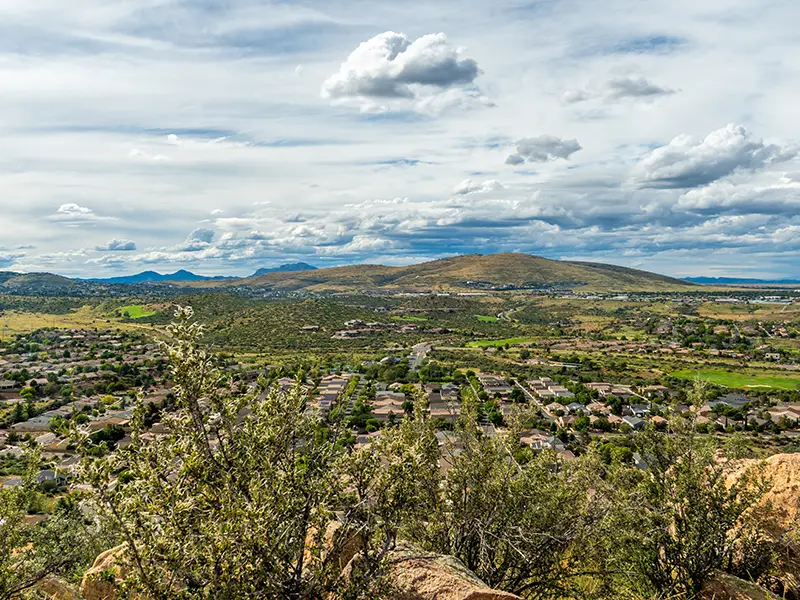 Scenic view of Arizona, with residential neighborhoods, rolling hills, and mountains, representing damage restoration in Prescott Valley.